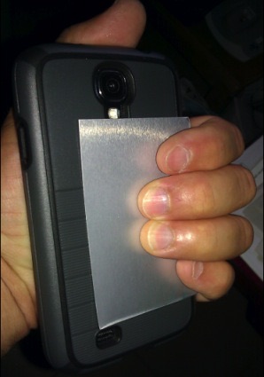 Photo of the same test phone with the silver Bodywell card attached to the back battery cover